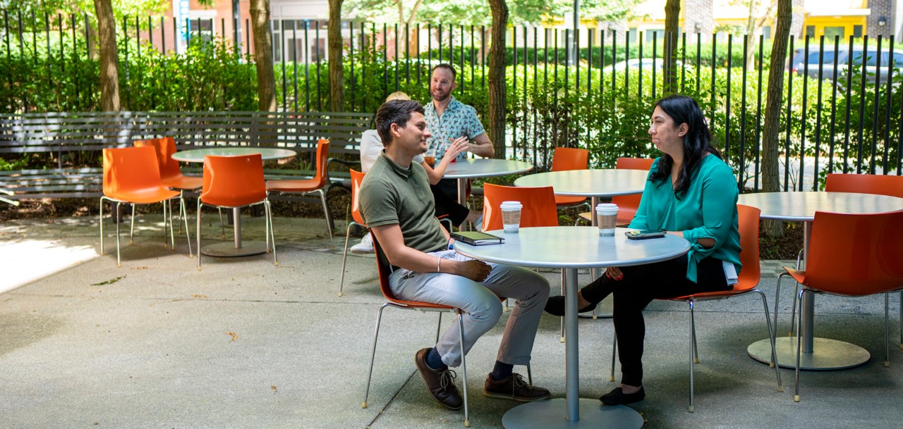 Photo of two employees having a conversation outside