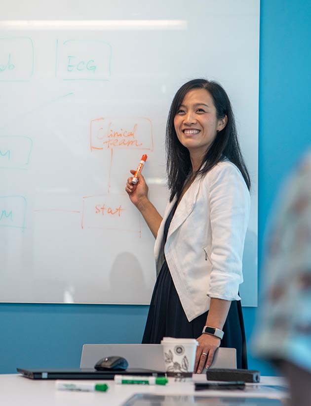 Woman working at a white board