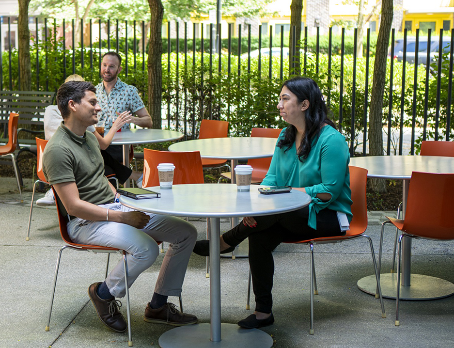 Photo of two employees having a conversation outside