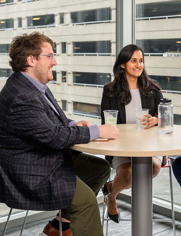 Three colleagues sitting at a table for a discussion