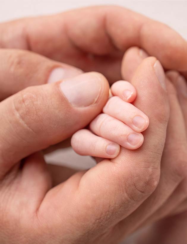 Adult hand and baby hand