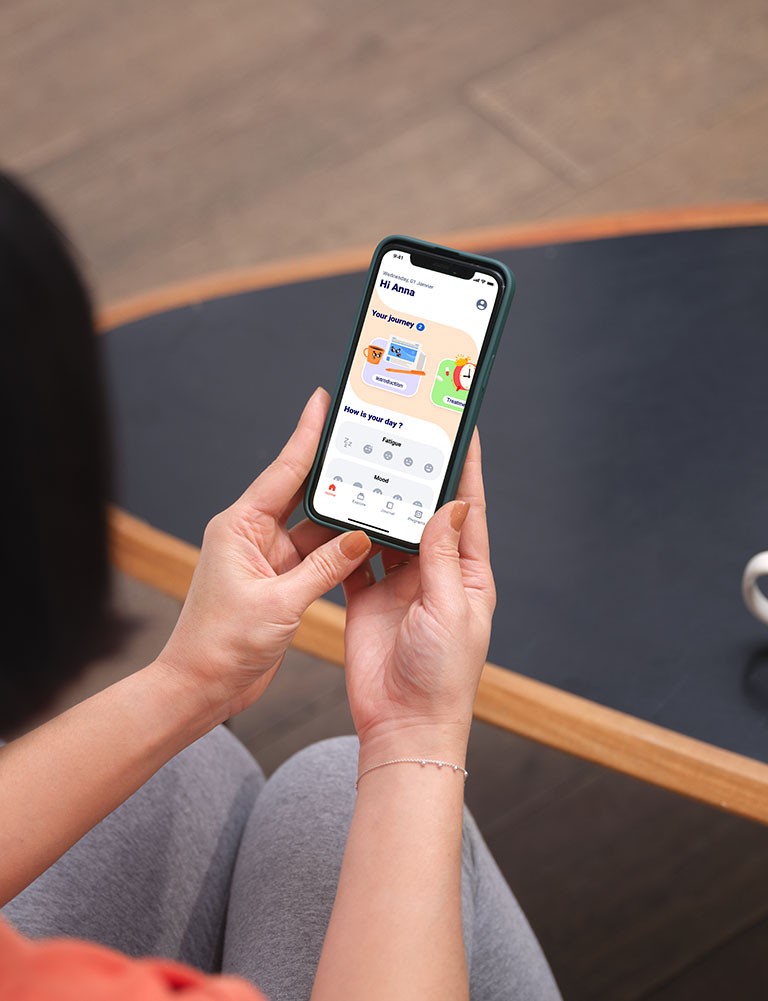 Woman holding phone with app open