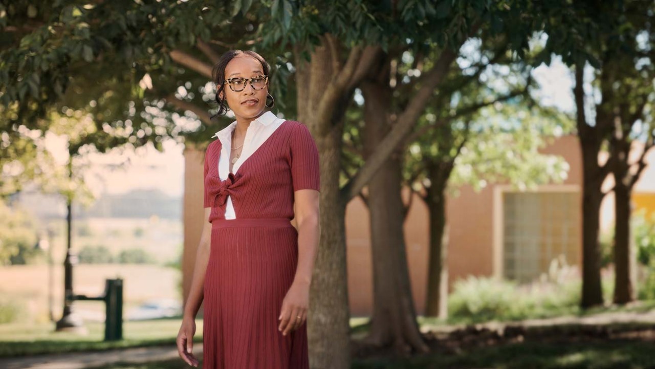 Lauren, living with MS, standing outside and looking away