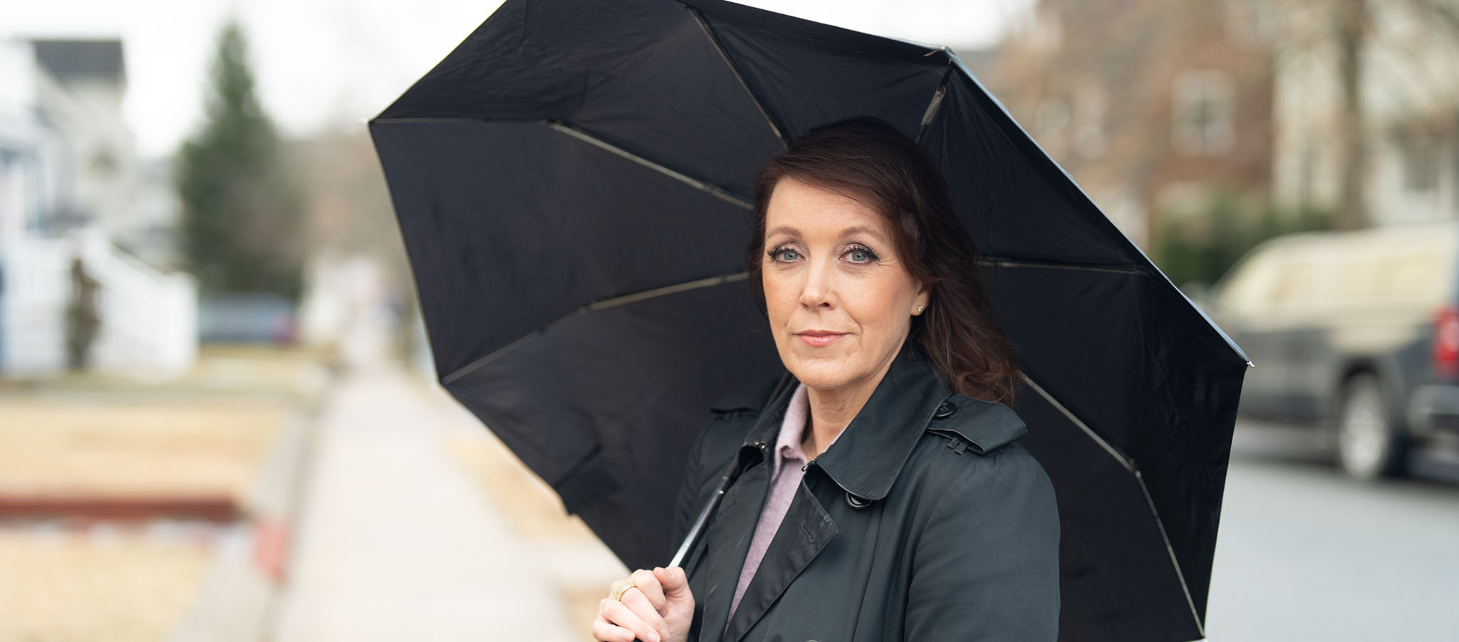 Monica standing with umbrella