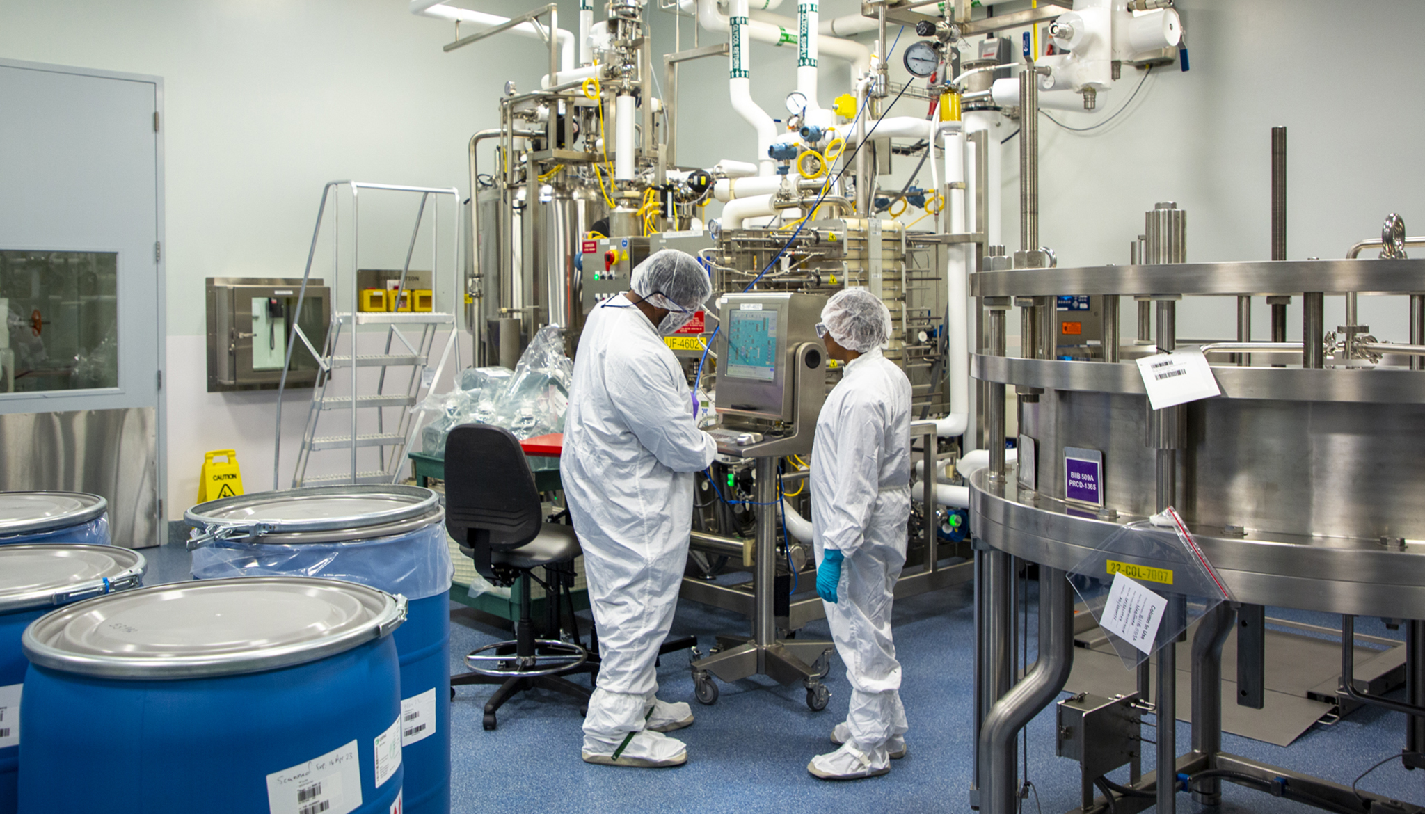 Two Biogen associates in a manufacturing facility