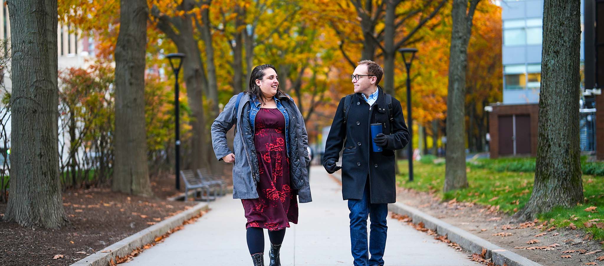 Two employees walking on campus