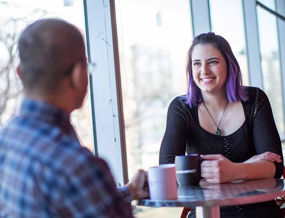 Photo of two employees having a conversation