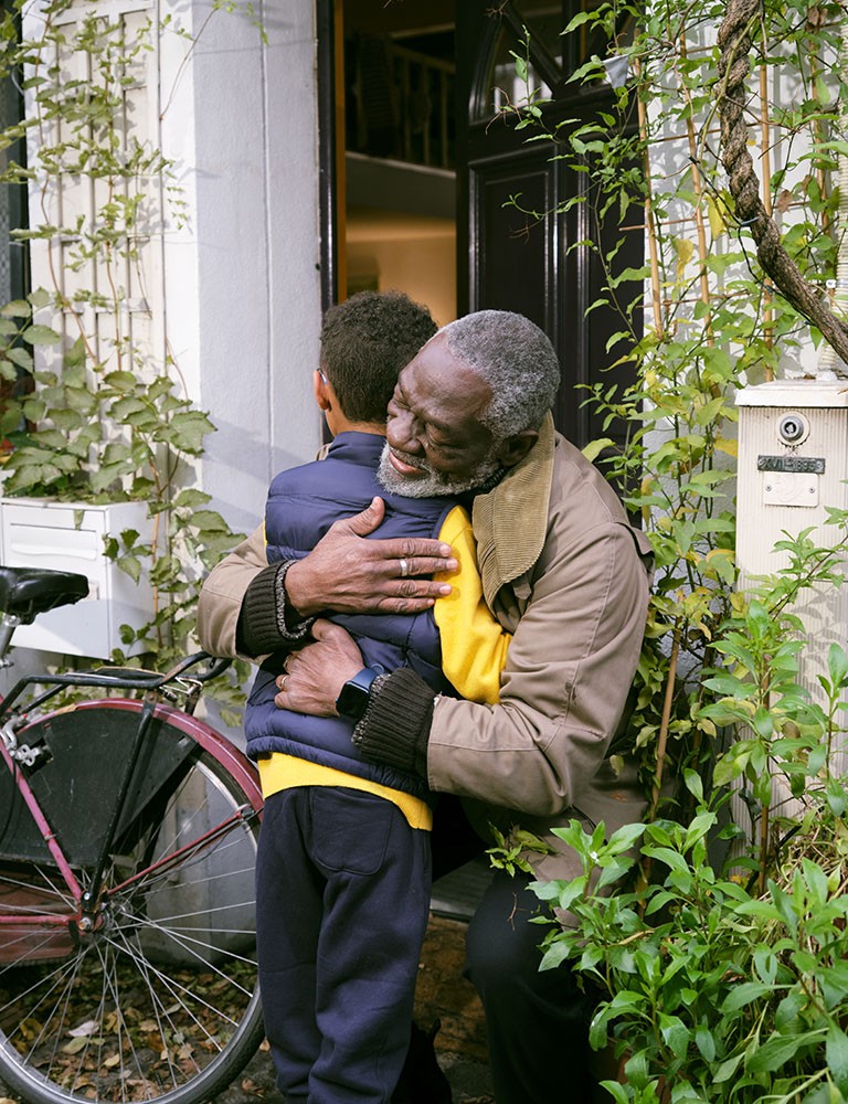 older man hugging grandson
