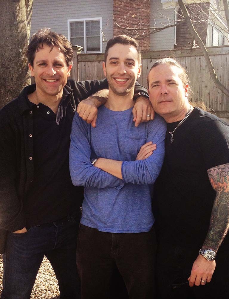 Jeremy (living with ALS) and his cousins Jon and Seth smiling